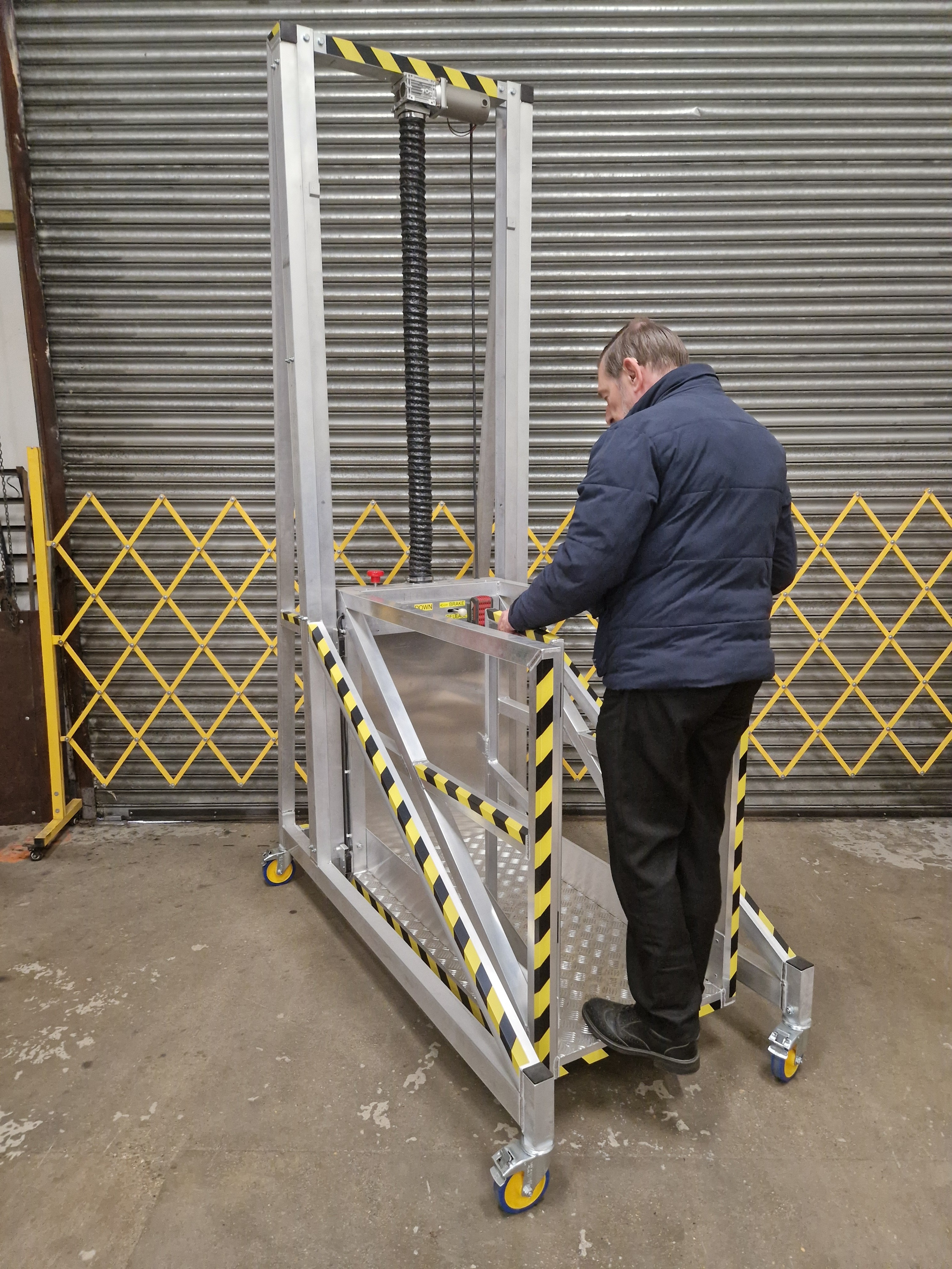 Mobile access platform equipment enabling safe working at height from ground level to 1.5m platform in industrial environment.