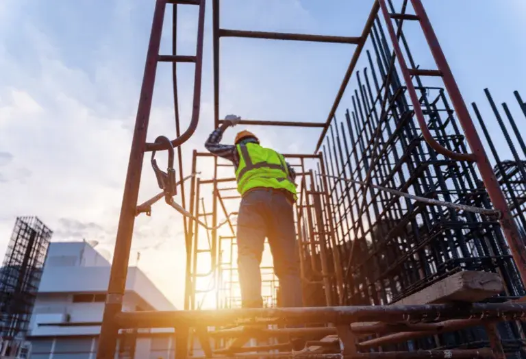 A man working at height in hot temperatures using the necessary precautions to stay safe.