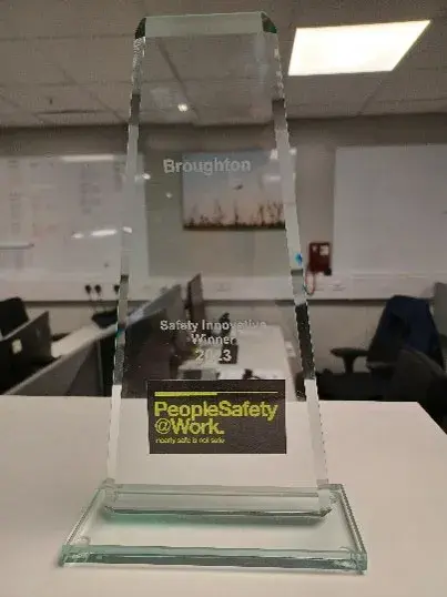 An award for safety at work which is placed on a desk.