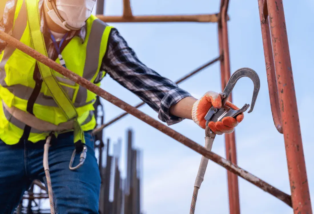 Self-employed worker wearing a safety harness to prevent any falls from height.