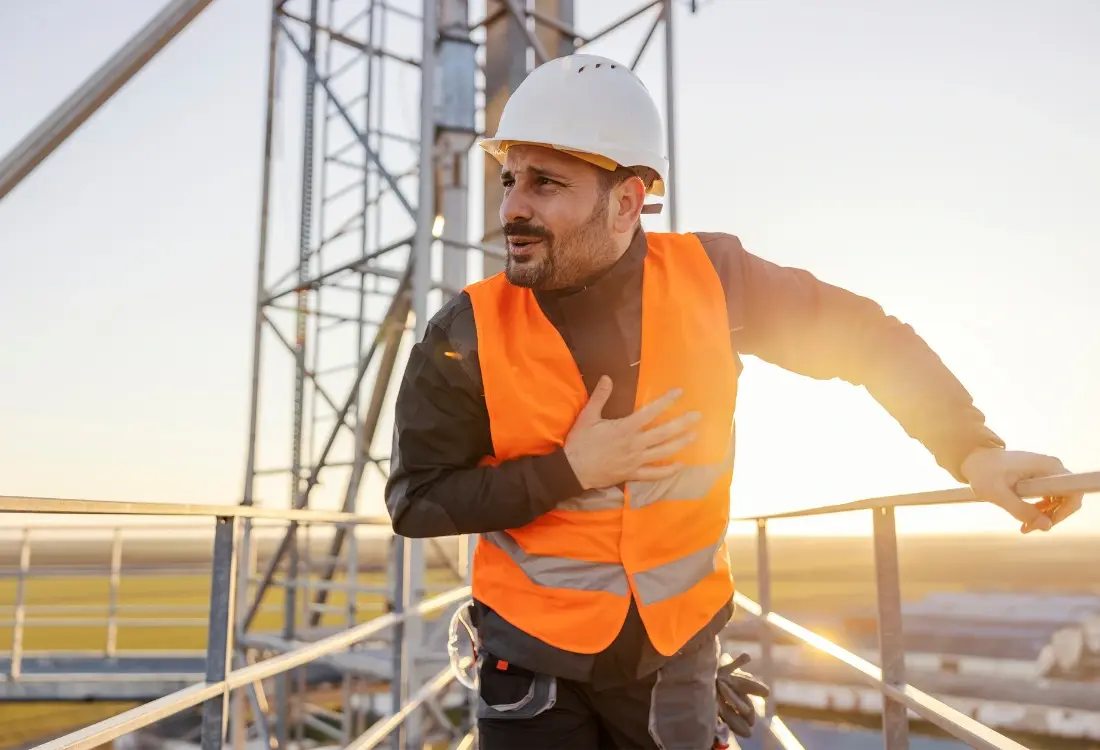 Construction worker feeling scared on a platform because he knows the hazards for working at height alone.