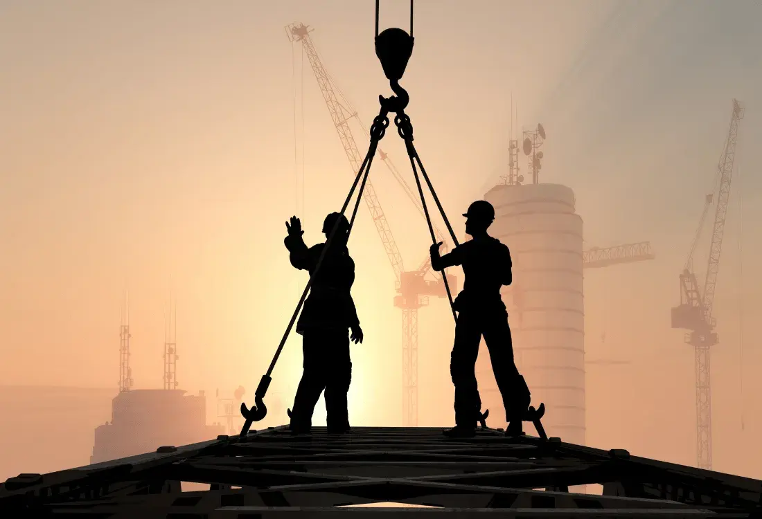 Two construction workers discussing how to build at height safely.