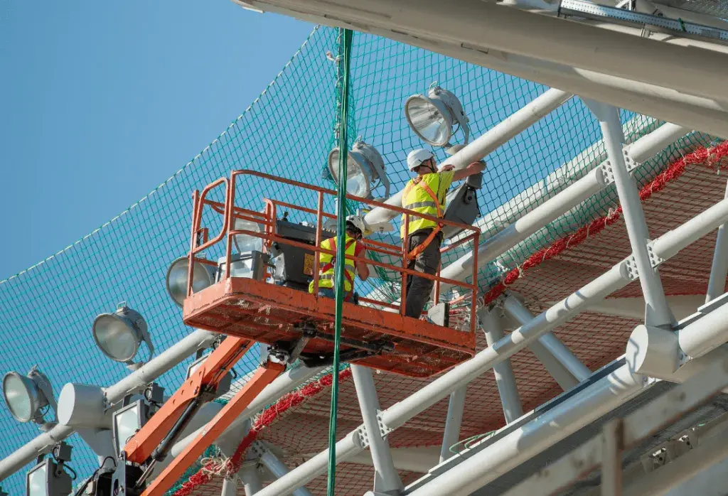 2 workers working safely as they are required hire working at height equipment
