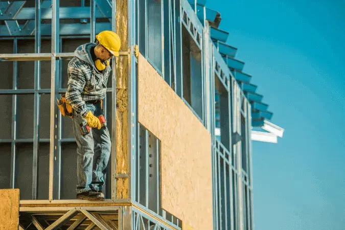 a construction worker on a high site to show that he's safe in autumn conditions.
