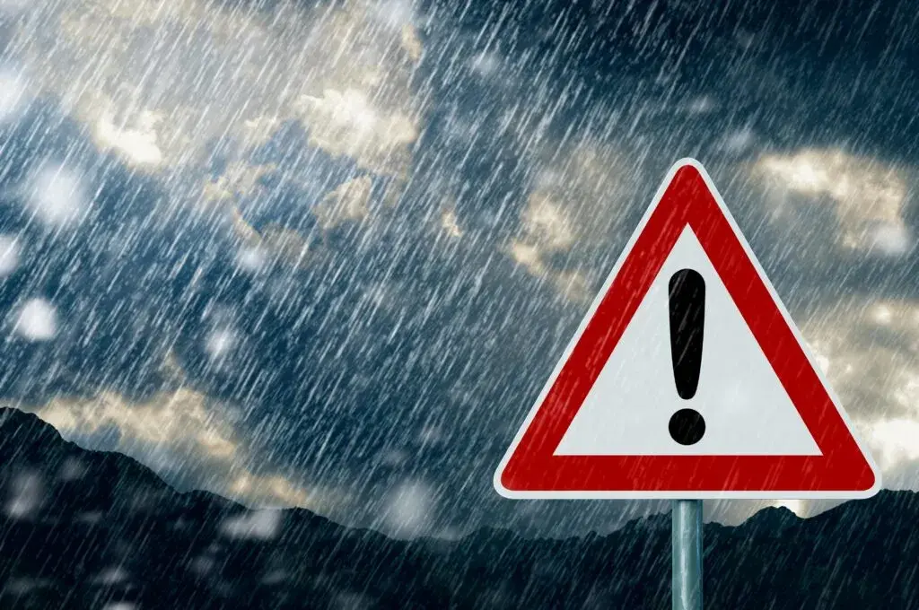 Bad weather and a warning sign to show the dangers of working at height in bad weather conditions