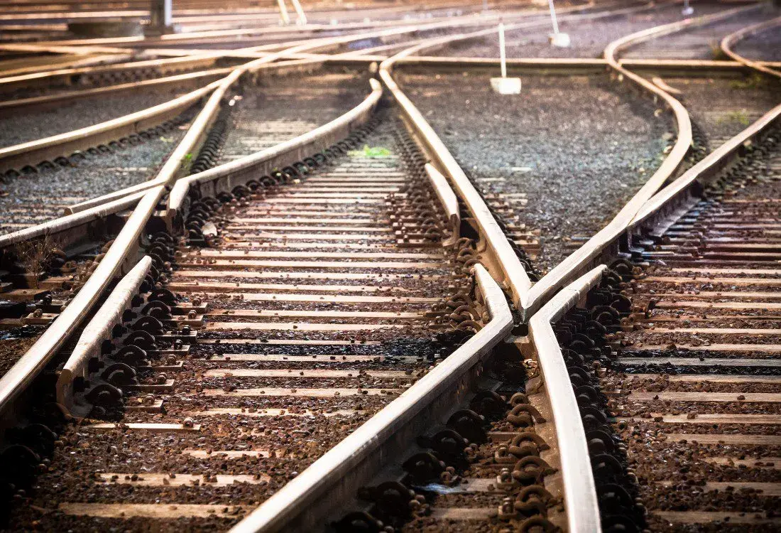 A close up of train tracks which are going in different directions.