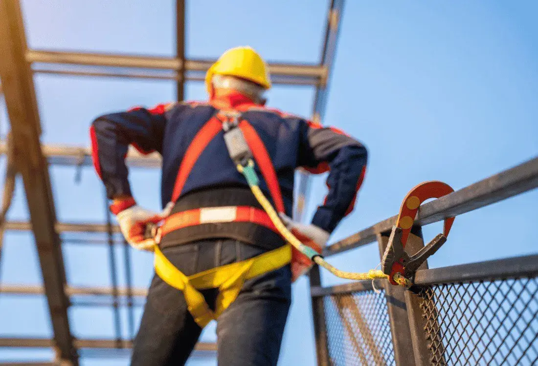 A worker using safety equipment as he prepares to use the CHAMP.