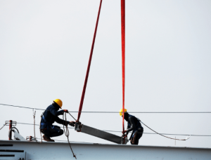 Two people working at height on a construction site.